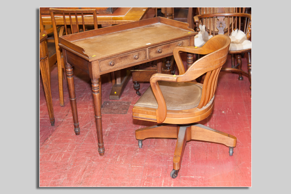 A late 19th Century mahogany desk type table having a narrow railback with two drawers and corner