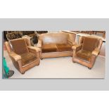 A three piece Art Deco rexine covered suite of two seater couch and a pair of armchairs on oak bun