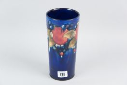 A Moorcroft slender chimney vase of tapering form, all over cobalt blue ground having tube lined