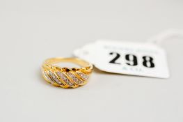 An eighteen carat gold ring with tiny diamonds in swirl form, 5 grms approximately