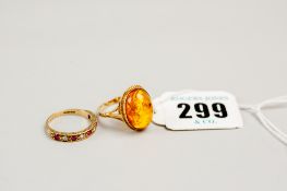 A nine carat gold oval amber dress ring, 3.2 grms approximately and a nine carat gold half hoop