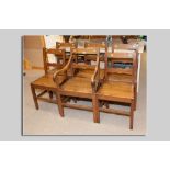 A set of six (five plus one carver) antique oak Anglesey farmhouse chairs with decoration by