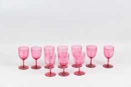 Nine cranberry glass wine glasses with etched decoration