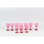 Nine cranberry glass wine glasses with etched decoration