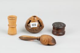 A group of four treen items to include a carved nutcracker, a decorative  brazil nut pod, a rosewood