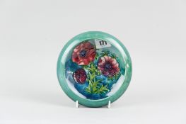 A Moorcroft pottery bowl with inverted rim, the interior decorated in the anemone pattern and an