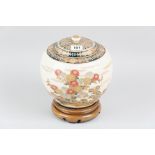 A 19th Century Japanese Satsuma baluster jar with stylised floral decoration, knopped cover and