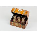 A walnut dome topped scent bottle casket with chased brass strap and button banding, pierced brass