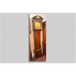 A late 18th Century Irish mahogany longcase clock, the hood with broken architectural pediment and