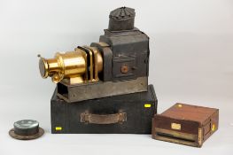 A tinware and brass Magic Lantern with tinware carry case (possibly associated), a brass mounted and