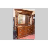 A late Victorian mahogany mirror backed sideboard having carved panels surrounding the central