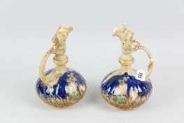 A pair of Austria Vienna blue ground narrow necked vases with raised floral decoration and with a
