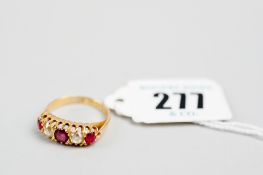 An 18ct gold dress ring having three rubies and two diamonds, visual estimate 0.3 carats each, 4 gms