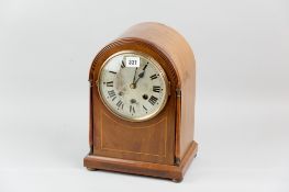 A late nineteenth/early twentieth century mahogany and inlaid domed top mantel clock, bevelled glass