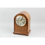 A late nineteenth/early twentieth century mahogany and inlaid domed top mantel clock, bevelled glass