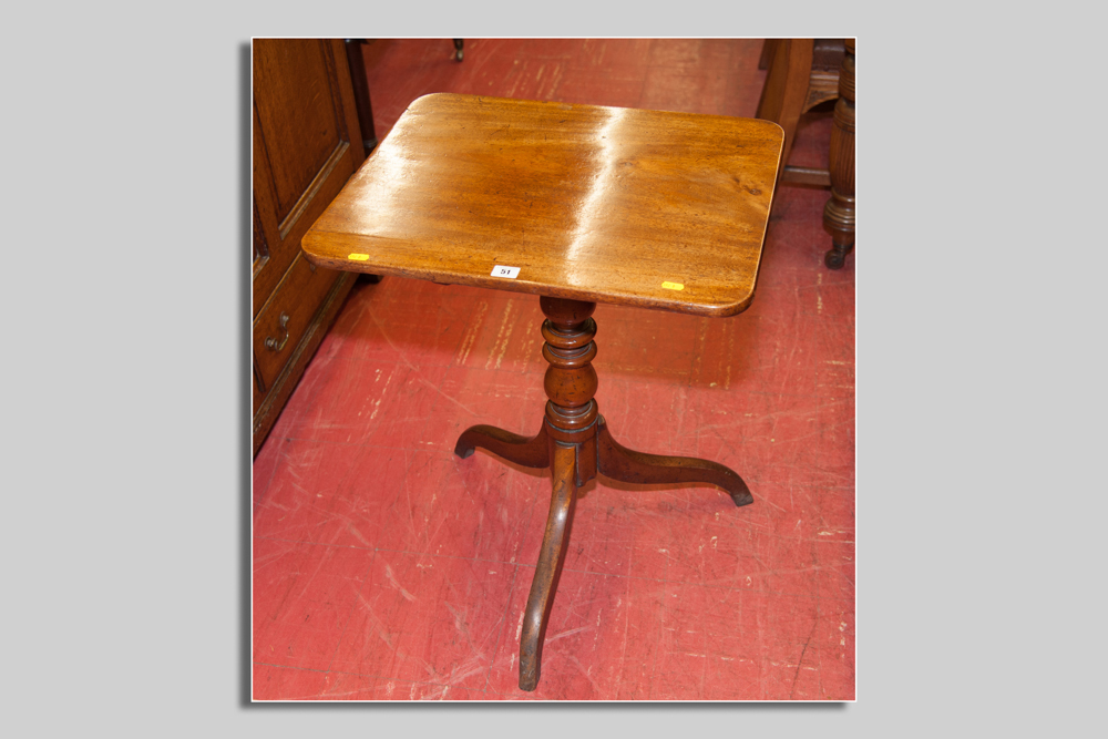 A Victorian mahogany tilt top tripod table, the near square top over a turned centre pedestal and