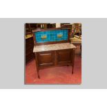 An Edwardian mahogany tile topped washstand with pink marble surface, the tile back with Majolica