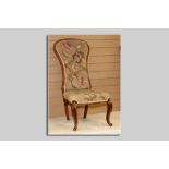 A Victorian mahogany narrow spoonbacked armless chair on cabriole and knurl front supports and