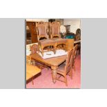 An excellent Edwardian oak dining table and six chairs, a wind-out dining table with two extra