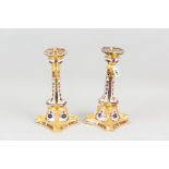 A pair of Royal Crown Derby old Imari candle holders, each on a square shaped base with shaped