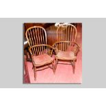 Two near matching Windsor elm spindlebacked elbow chairs with turned ring supports and cross
