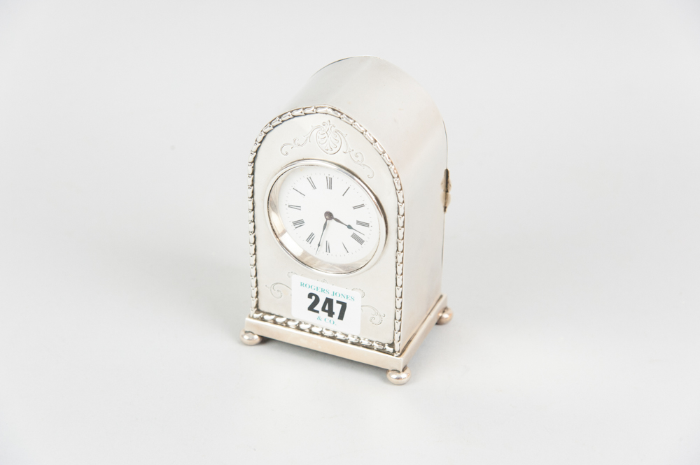 A fine quality dome topped silver encased mantle clock, the front having dart edging with bright cut