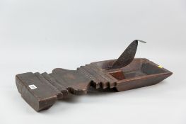 A nineteenth century South Sea Island coconut splitter, the hardwood utensil with carved square dish