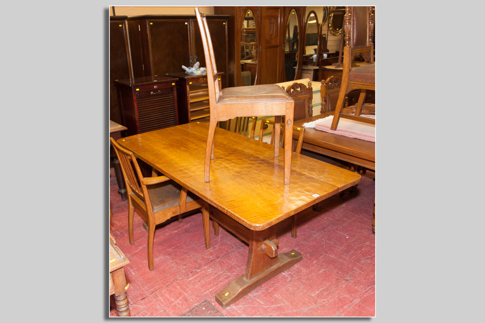 A set of four (three plus one diner) spindlebacked oak chairs with acorn motif by Alan Granger of