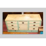 A Victorian painted pine kitchen dresser base, plain railback painted top over three frieze