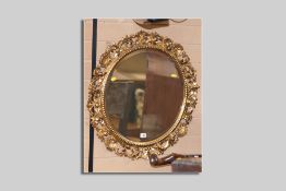 A good quality late 19th/early 20th Century circular bevelled edge wall mirror with carved wood
