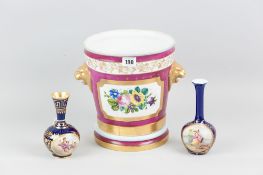 A continental porcelain planter pot having a floral panel back and front and with gilt lion mask