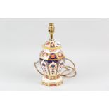 A Royal Crown Derby Imari patterned octagonal based table lamp of shaped form with a stepped