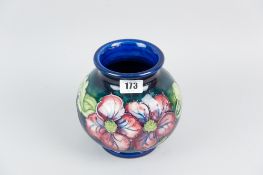 A Moorcroft pottery globular vase, a predominantly cobalt blue bodied vase with tube line decoration