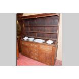 A late 18th Century flat fronted oak Welsh dresser, the three shelf rack with shaped sides (pot