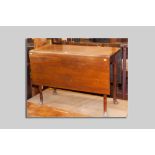 A Georgian mahogany drop leaf dining table with tapered turned supports and pad feet,
