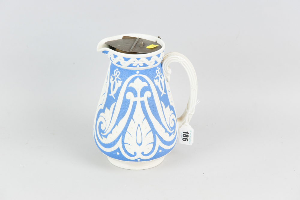A Copeland blue ground semi-glazed narrow neck jug with raised Gothic style pattern, scrolled handle