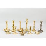 A large parcel of mixed brass chambersticks and candlesticks