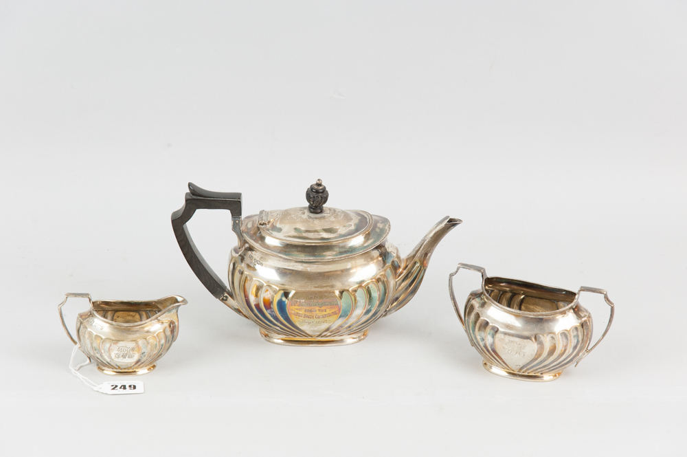 A three piece silver bachelor tea service, each piece of oval form with raised and swirled