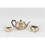 A three piece silver bachelor tea service, each piece of oval form with raised and swirled