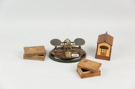 A set of brass desk top scales on an oval rosewood and ebony base, a sandalwood stamp box, one