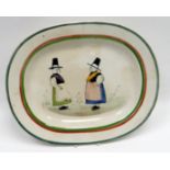 LLANELLY POTTERY - oval meat platter hand-painted with two confronting female figures in folk
