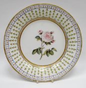 NANTGARW porcelain - circular plate of plain form, probably London painted with centre rose stem and