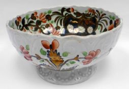 GAUDY WELSH POTTERY (STAFFORDSHIRE) - a punch bowl with crimped rim, moulded body and moulded foot