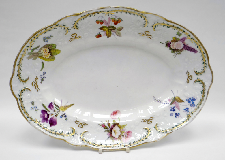 NANTGARW porcelain - oval dish of alternating lobed form with a floral moulded border, with