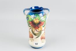 A good Moorcroft pottery 'Anna Lily' decorated twin handled vase, 25.5 cms high (one slight glaze