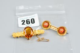 A filigree decorated oblong pinchbeck brooch with large oval amber stone, 6 grms and a pinchbeck