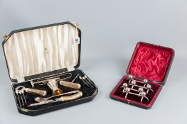 A cased thirteen piece aperitif set, some of the pieces all metal, others bone handled and a cased