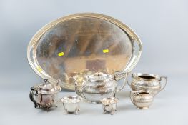 An oval plain electroplated tray with a three piece electroplated bachelor tea service of plain form