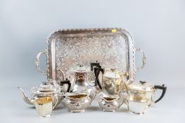 An oblong electroplated bright cut tray with two four piece electroplated tea and coffee services