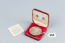 A cased John Pinches medal commemorating Sir Winston Churchill, marked silver with portrait of the